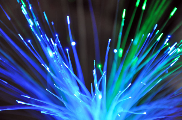 Close-up of a light fiber bundle glowing in the dark, abstract backgound - Photo, Image