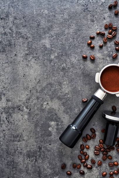 Top view of coffee background. Assorted coffee beans, ground coffee, portafilter and tamper on dark concrete background. Flat lay. Copy space for text. Barista concept. - Foto, imagen