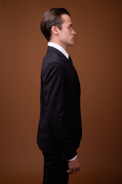 Profile view of young Caucasian businessman wearing suit - Fotografie, Obrázek