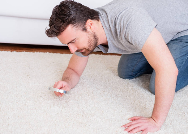 Man checking for carpet dust mites and bug parasites - Photo, Image