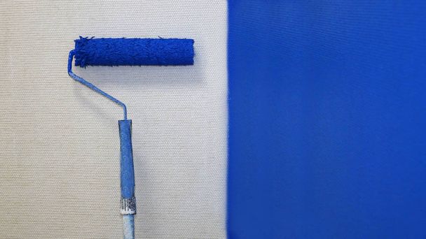 De roller verf de muur blue.worker, vacature - Foto, afbeelding