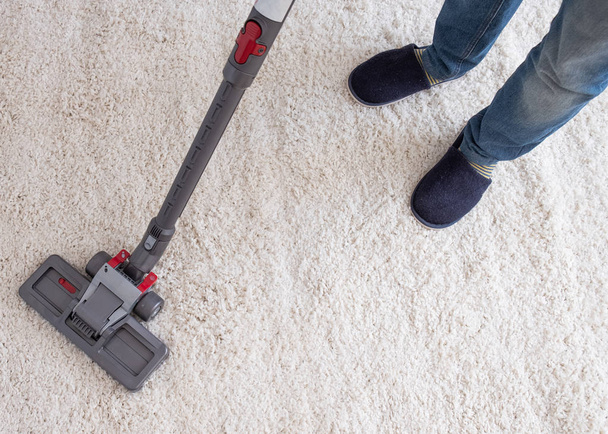 Vacuuming the living room carpet at home - Fotoğraf, Görsel