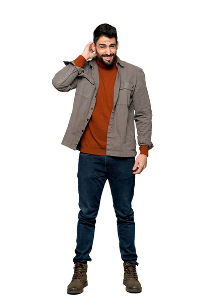 Full-length shot of Handsome man with beard having doubts on isolated white background - Photo, Image