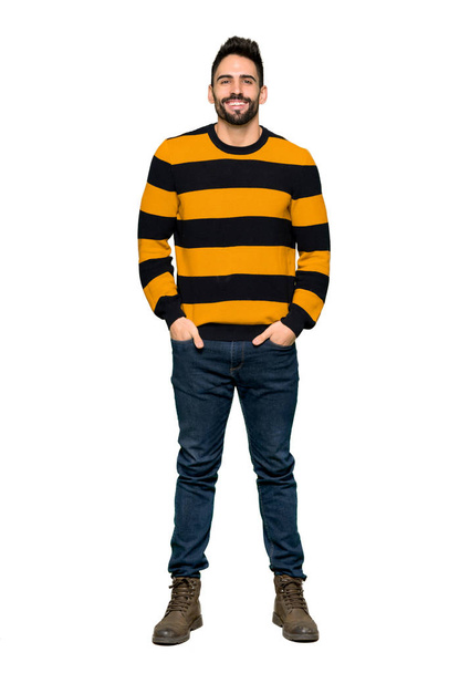 Full-length shot of Handsome man with striped sweater posing and laughing looking to the front on isolated white background - Foto, imagen