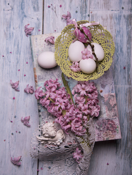 Happy Easter card template with pink Hyacinth flowers and eggs on wooden background  - Photo, Image
