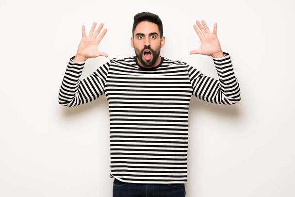 handsome man with striped shirt with surprise and shocked facial expression - Zdjęcie, obraz