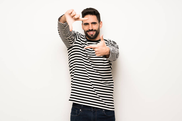 handsome man with striped shirt focusing face. Framing symbol - Foto, imagen