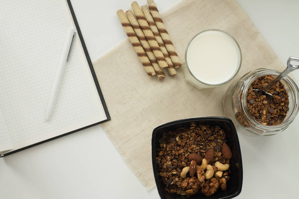 homemade baked muesli and milk on white background, top view, horizontal - Photo, Image
