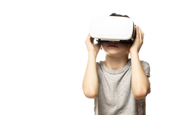 Boy experiencing virtual reality. Portrait. Isolate on white background. Front view. Technology concept. - Фото, изображение