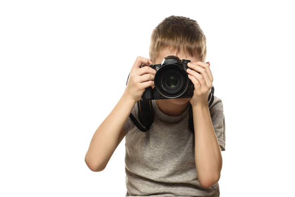 Boy takes pictures on the camera. Portrait. Isolate on white background. - Photo, Image