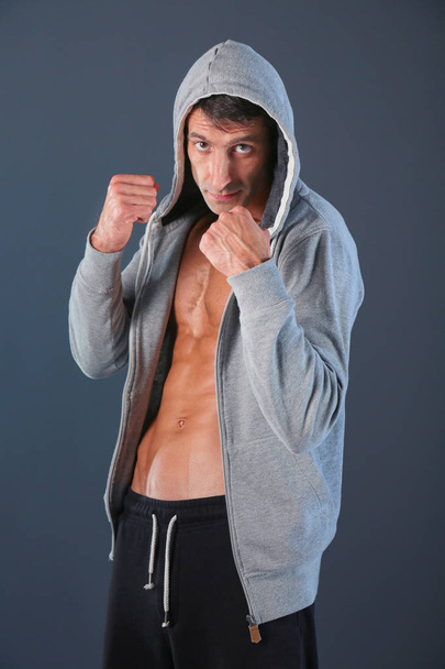 Profile view of young man practicing boxing .Personal instructor. Personal training. - Foto, imagen