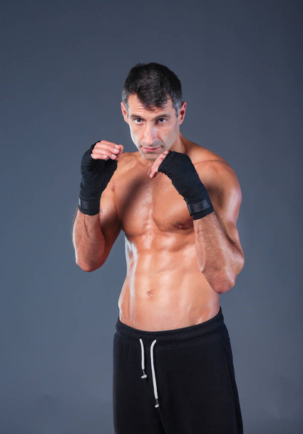 portrait of hand wrapping half nude boxer. Personal fitness instructor. Personal training. - Foto, Imagen