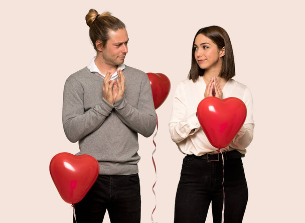 Paar am Valentinstag intrigiert etwas über isolierten Hintergrund - Foto, Bild