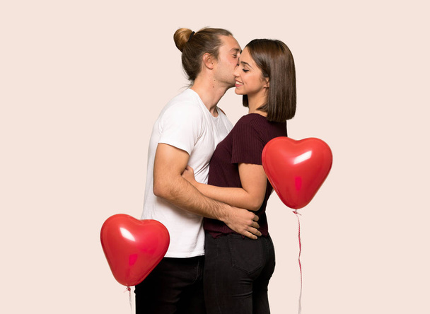 Couple in valentine day kissing over isolated background - Photo, image