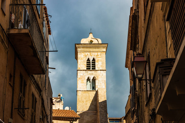 The bell tower of the Basilica of Saint Mary Major, a Romanesque-style Roman Catholic church located in Bonifacio, Corsica. - Zdjęcie, obraz