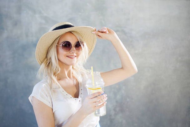 Young beautiful blonde woman in straw hat. Summer style sunglasses. - Zdjęcie, obraz