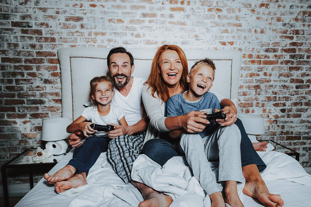Happy family playing on game console and having fun - Foto, Imagem
