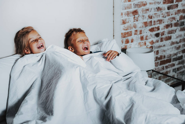 Two happy kids watching funny program at home - Valokuva, kuva