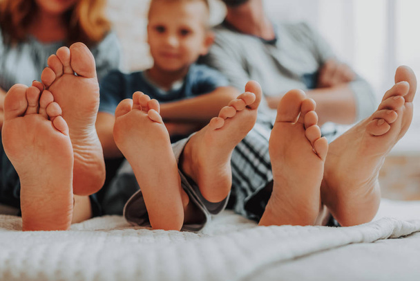 Close up family three pairs of feet in bed - Foto, Imagem