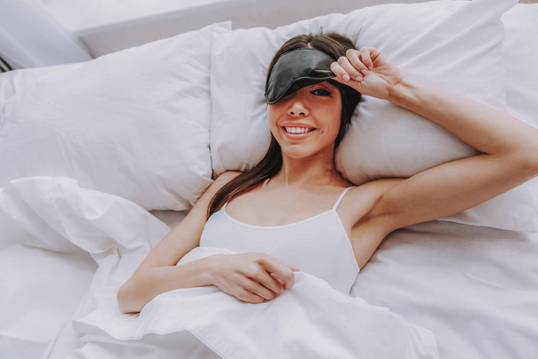 Happy young woman waking up after sweet dream in morning - Foto, imagen