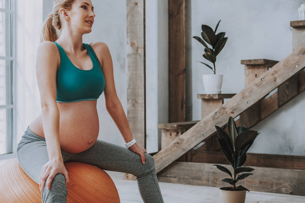 Healthy future mother practicing yoga on fitness ball - Valokuva, kuva