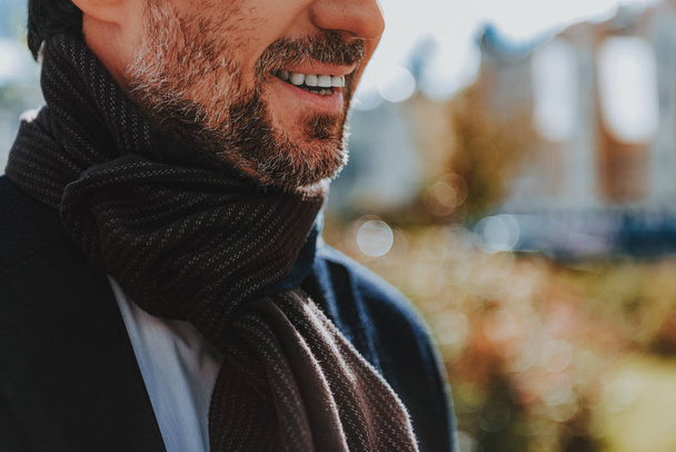 Bearded man with stubble is smiling outdoors - Photo, image