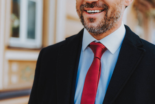 Cheerful man in formal clothes is smiling outside - Foto, immagini