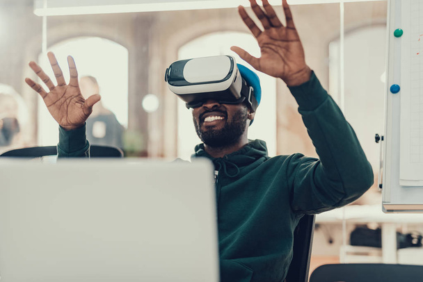 Excited man putting hands up while exploring virtual reality - Foto, immagini