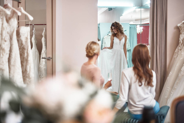 Young smiling lady trying on bridal dress - Fotoğraf, Görsel