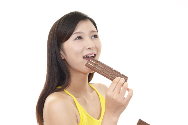 Feliz joven comiendo chocolate
 - Foto, imagen