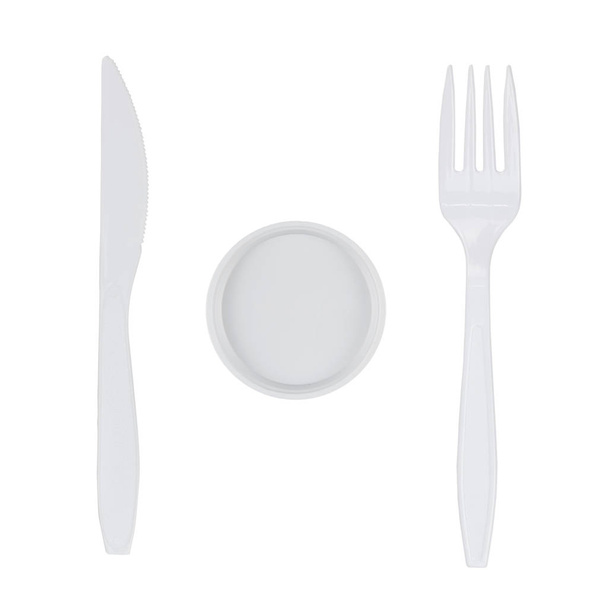 weiße Kunststoffgabel, kleiner Teller und Messer isoliert auf weißem Hintergrund - Foto, Bild