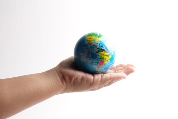 World globe  on a palm over a white. Globalization Concept - Zdjęcie, obraz
