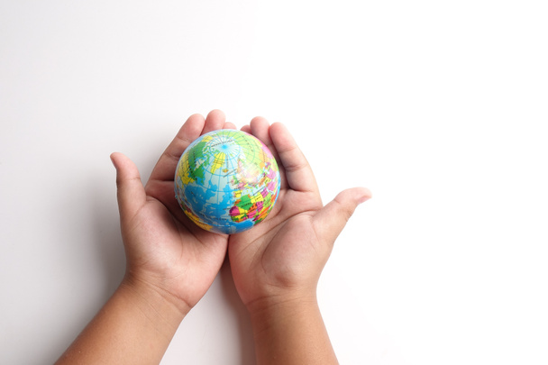 World globe  on a palm over a white. Globalization Concept - Fotografie, Obrázek