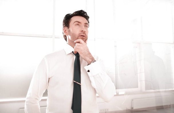 dreaming businessman standing in the office. - Foto, imagen