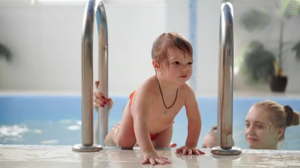 Los bebés que suben de la piscina ayudan a la madre en cámara lenta
 - Imágenes, Vídeo