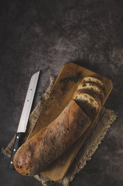 Fresh pastry baguette with herbs, garlic from home bakery - Fotó, kép