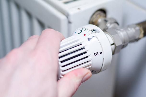 Close Up Of Hand Adjusting Heating Thermostat. - Photo, Image