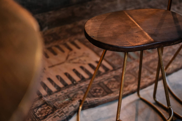 Rustic wood and bronze metal bar stools. Close up details. Coffee shop, home loft interior design, minimalism concept - Foto, Imagen