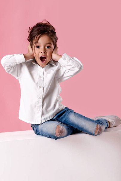 Cute surprised little girl in white shirt with hairstyle - Foto, immagini