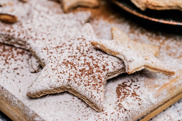 Star shaped christmas cookies decorated sugar and cocoa powder, close-up shot - Foto, Imagem