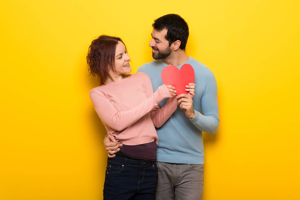 Couple in valentine day holding a heart symbol - Fotó, kép