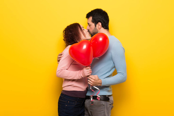 Pareja en día de San Valentín con globos con forma de corazón
 - Foto, imagen
