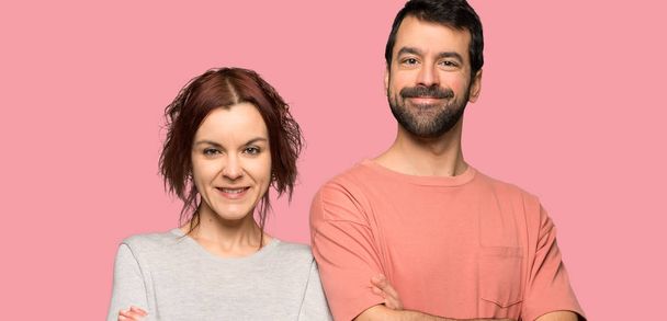 Couple in valentine day keeping the arms crossed over isolated pink background - Photo, Image