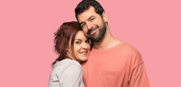 Couple in valentine day hugging over isolated pink background - Photo, Image