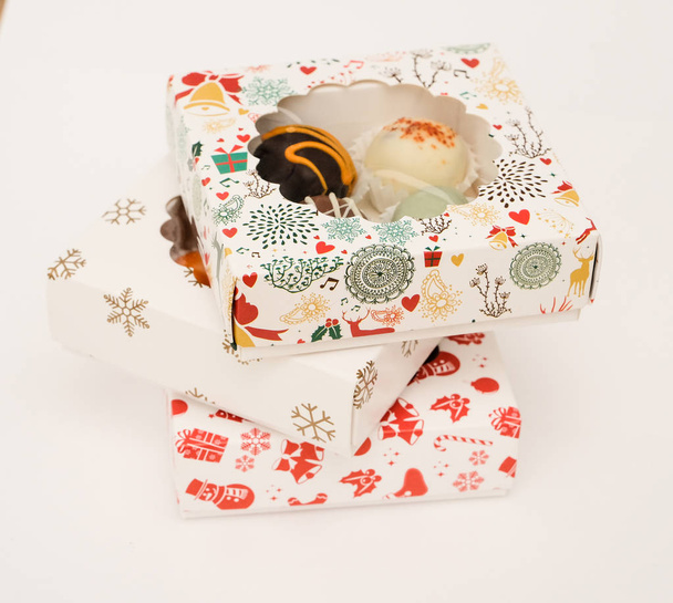 Appetizing truffles in festive boxes. White background. - Fotografie, Obrázek