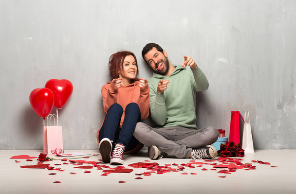 Couple in valentine day points finger at you with a confident expression - Foto, imagen