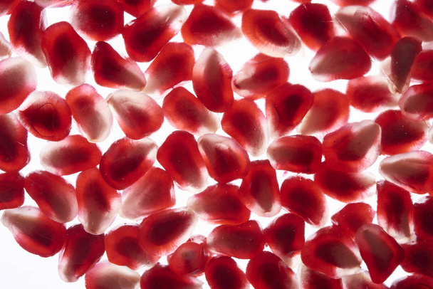 Fresh ripe pomegranate. Closeup macro view of pomegranate seeds. - Фото, зображення