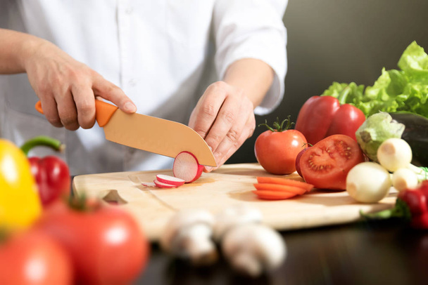 Chef prepares fresh vegetables. Cooking, healthy nutrition concept - Foto, imagen