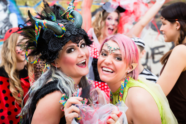 Women celebrating German Fasching Carnival in sexy costumes - Foto, imagen