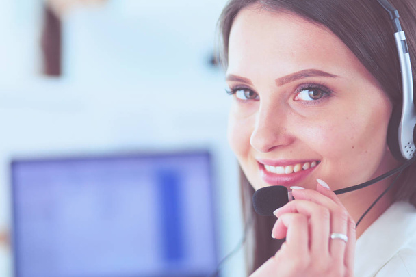 Smiling businesswoman or helpline operator with headset and computer at office - Foto, Imagem